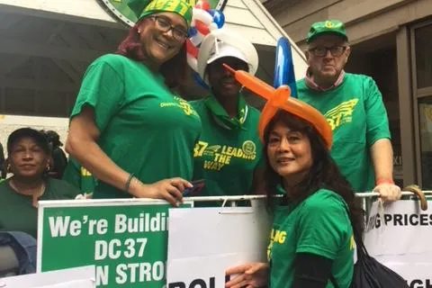 photo of Local 154 members with signs wearing green